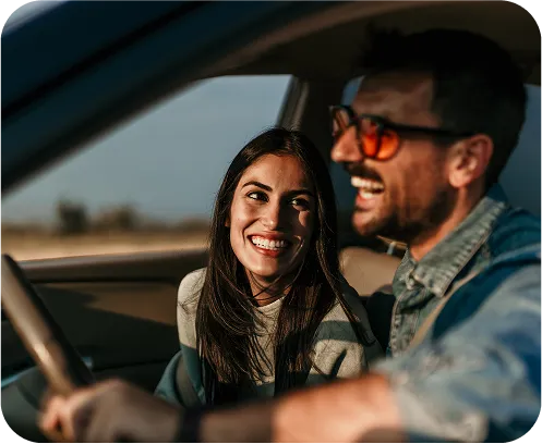 Happy couple driving a car